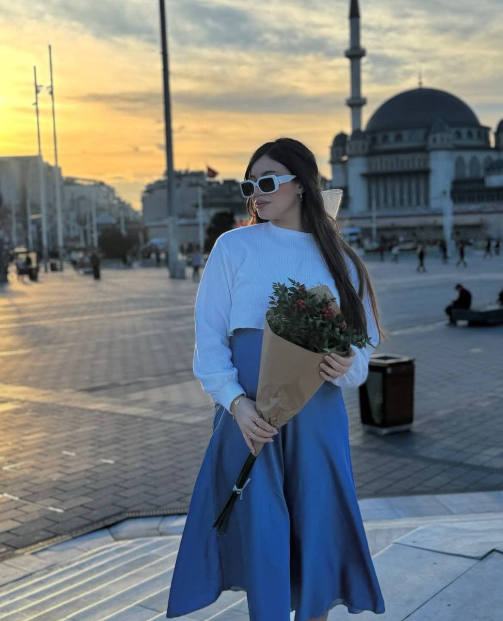 Blue satin midi skirt and white knit, styled on the street
